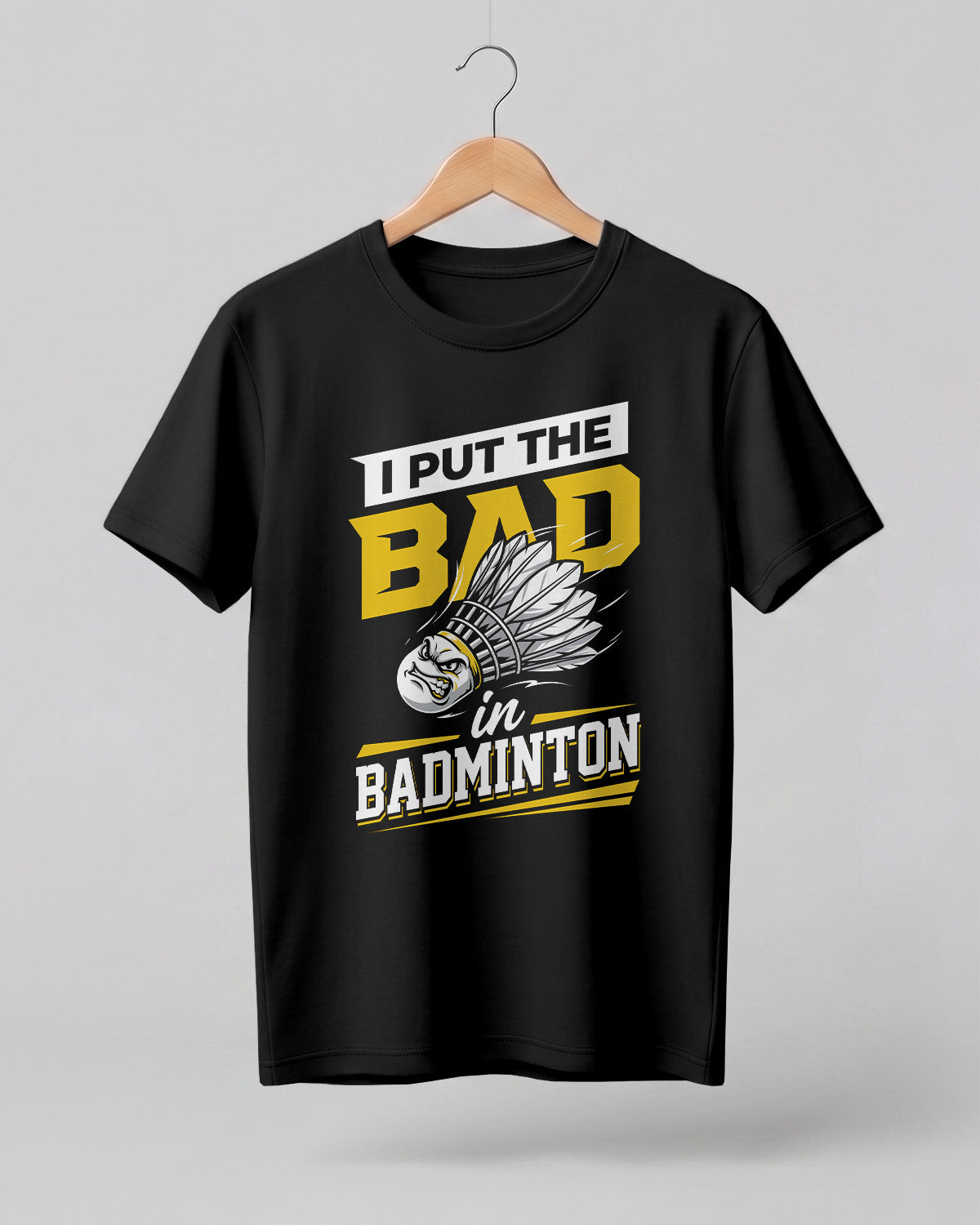 Humorous sports graphic half sleeve t-shirt featuring “I Put the Bad in Badminton” typography with shuttlecock illustration printed on premium cotton fabric.