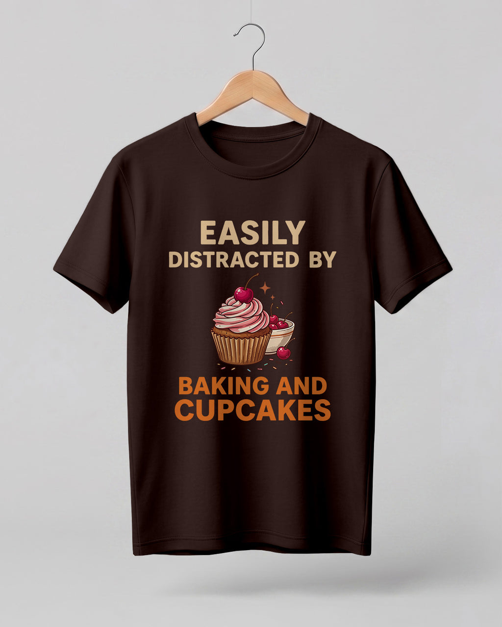 Foodie graphic half sleeve t-shirt featuring “Easily Distracted by Baking and Cupcakes” typography with colorful cupcake illustration printed on premium cotton fabric.