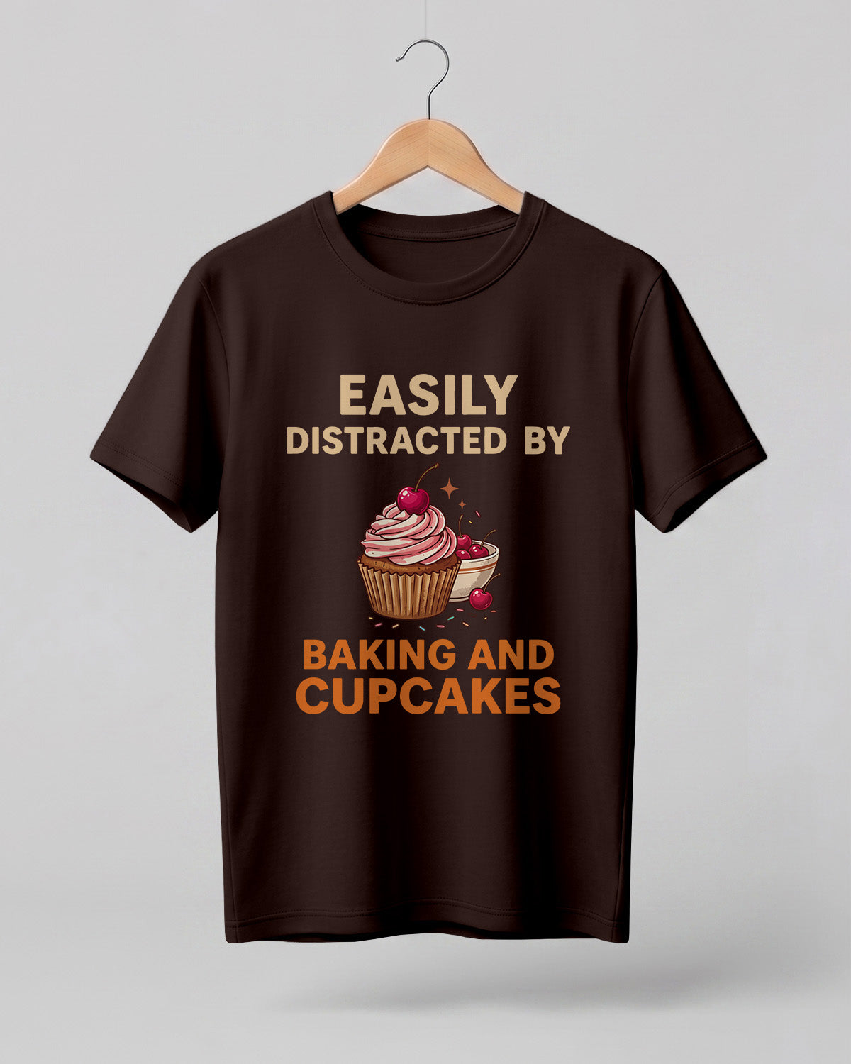 Foodie graphic half sleeve t-shirt featuring “Easily Distracted by Baking and Cupcakes” typography with colorful cupcake illustration printed on premium cotton fabric.
