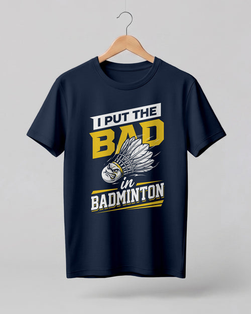 Humorous sports graphic half sleeve t-shirt featuring “I Put the Bad in Badminton” typography with shuttlecock illustration printed on premium cotton fabric.