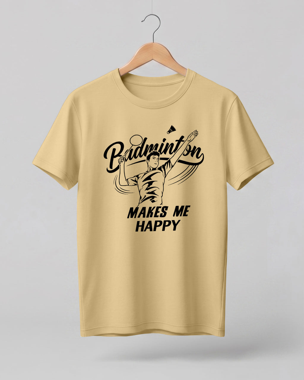Motivational sports graphic half sleeve t-shirt featuring “Badminton Makes Me Happy” typography with badminton player illustration printed on premium cotton fabric.