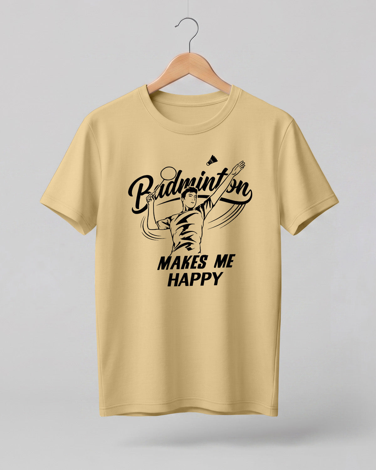 Motivational sports graphic half sleeve t-shirt featuring “Badminton Makes Me Happy” typography with badminton player illustration printed on premium cotton fabric.