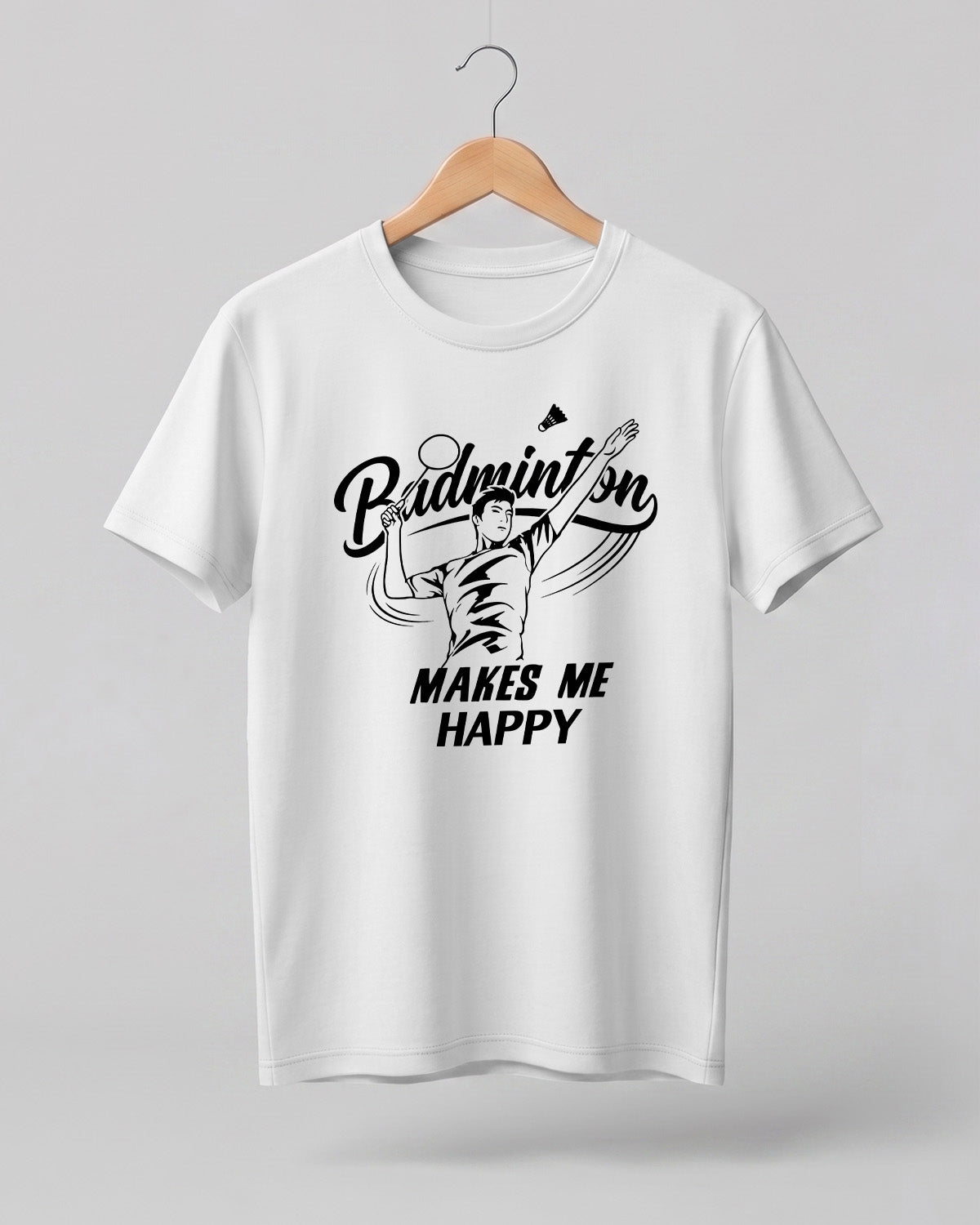 Motivational sports graphic half sleeve t-shirt featuring “Badminton Makes Me Happy” typography with badminton player illustration printed on premium cotton fabric.