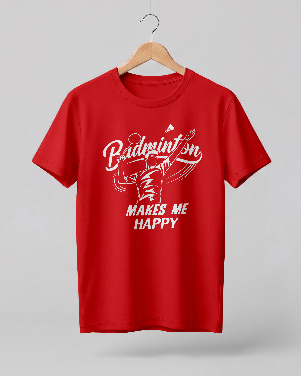 Motivational sports graphic half sleeve t-shirt featuring “Badminton Makes Me Happy” typography with badminton player illustration printed on premium cotton fabric.