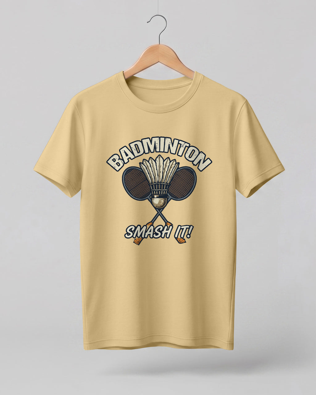 Motivational sports graphic half sleeve t-shirt featuring “Badminton Smash It!” typography with crossed racket and shuttlecock design printed on premium cotton fabric.