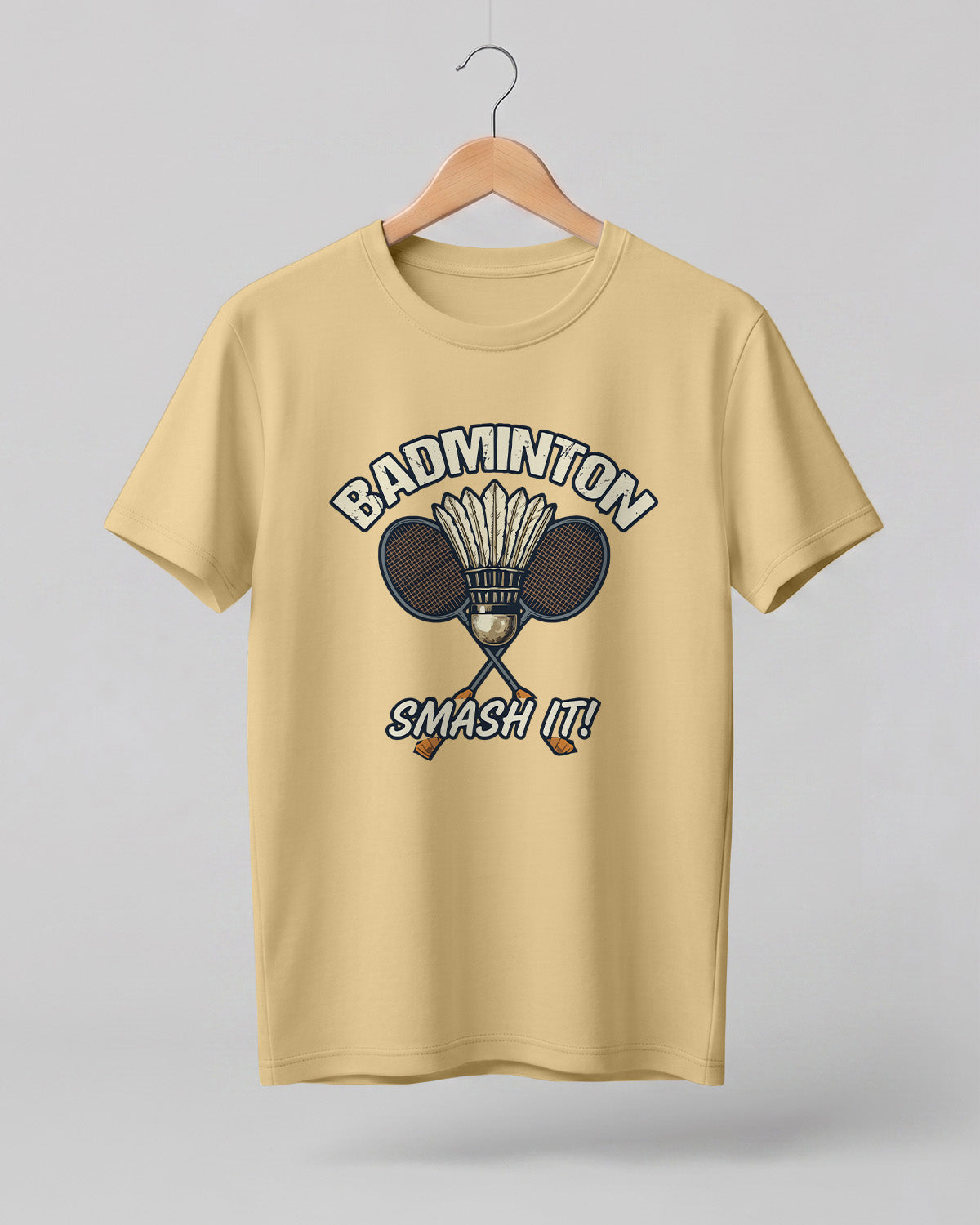 Motivational sports graphic half sleeve t-shirt featuring “Badminton Smash It!” typography with crossed racket and shuttlecock design printed on premium cotton fabric.