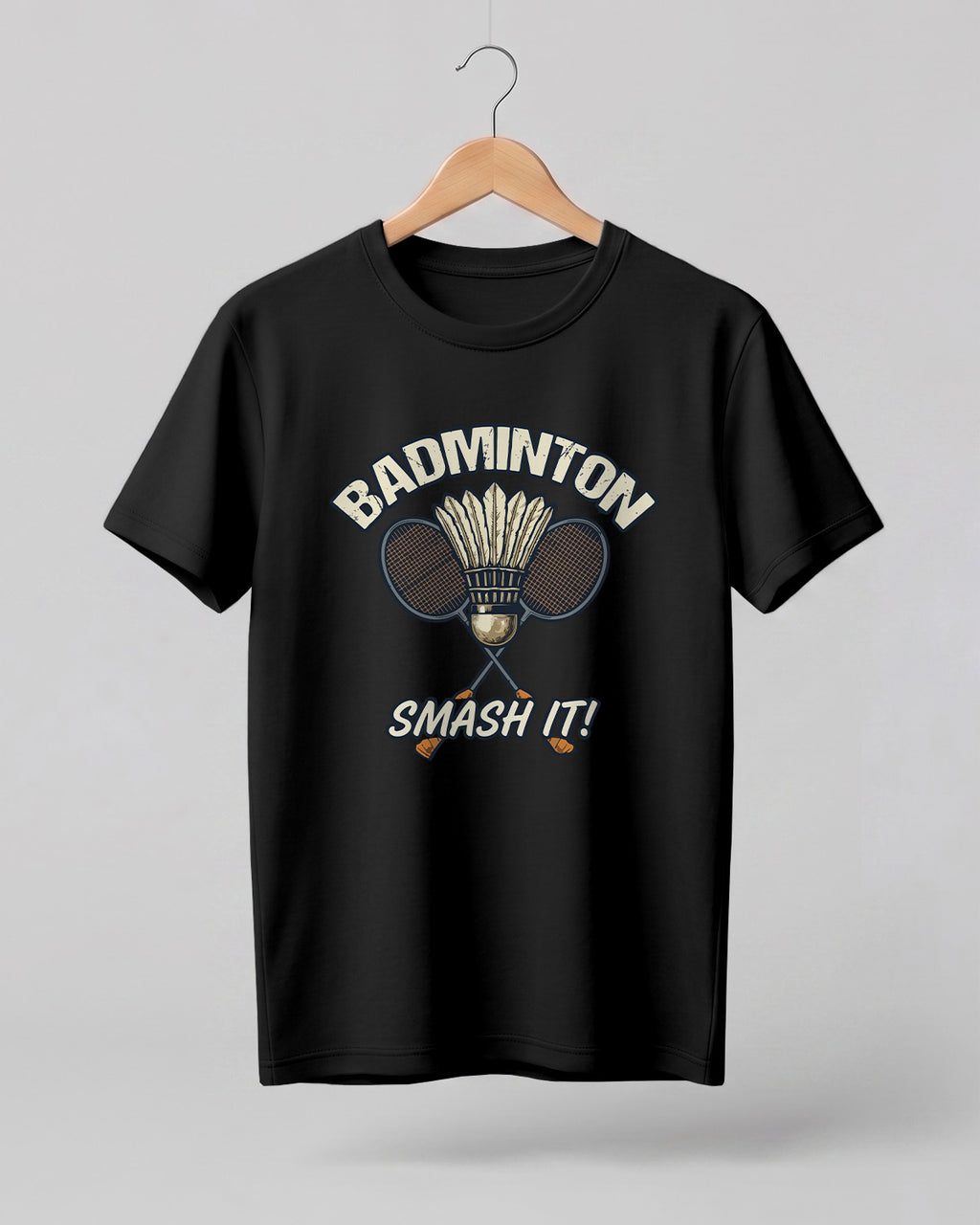 Motivational sports graphic half sleeve t-shirt featuring “Badminton Smash It!” typography with crossed racket and shuttlecock design printed on premium cotton fabric.