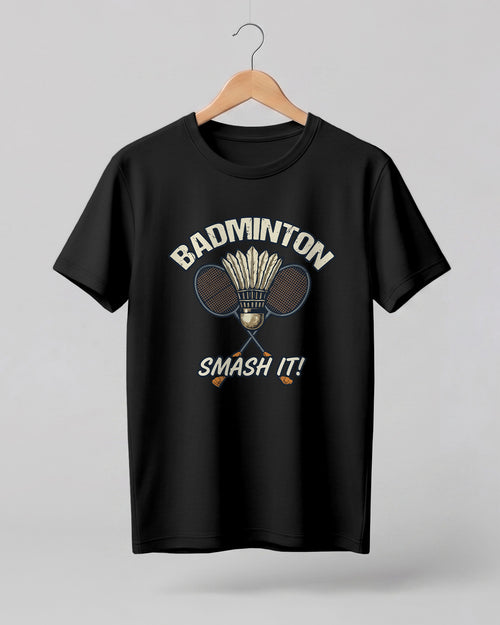 Motivational sports graphic half sleeve t-shirt featuring “Badminton Smash It!” typography with crossed racket and shuttlecock design printed on premium cotton fabric.