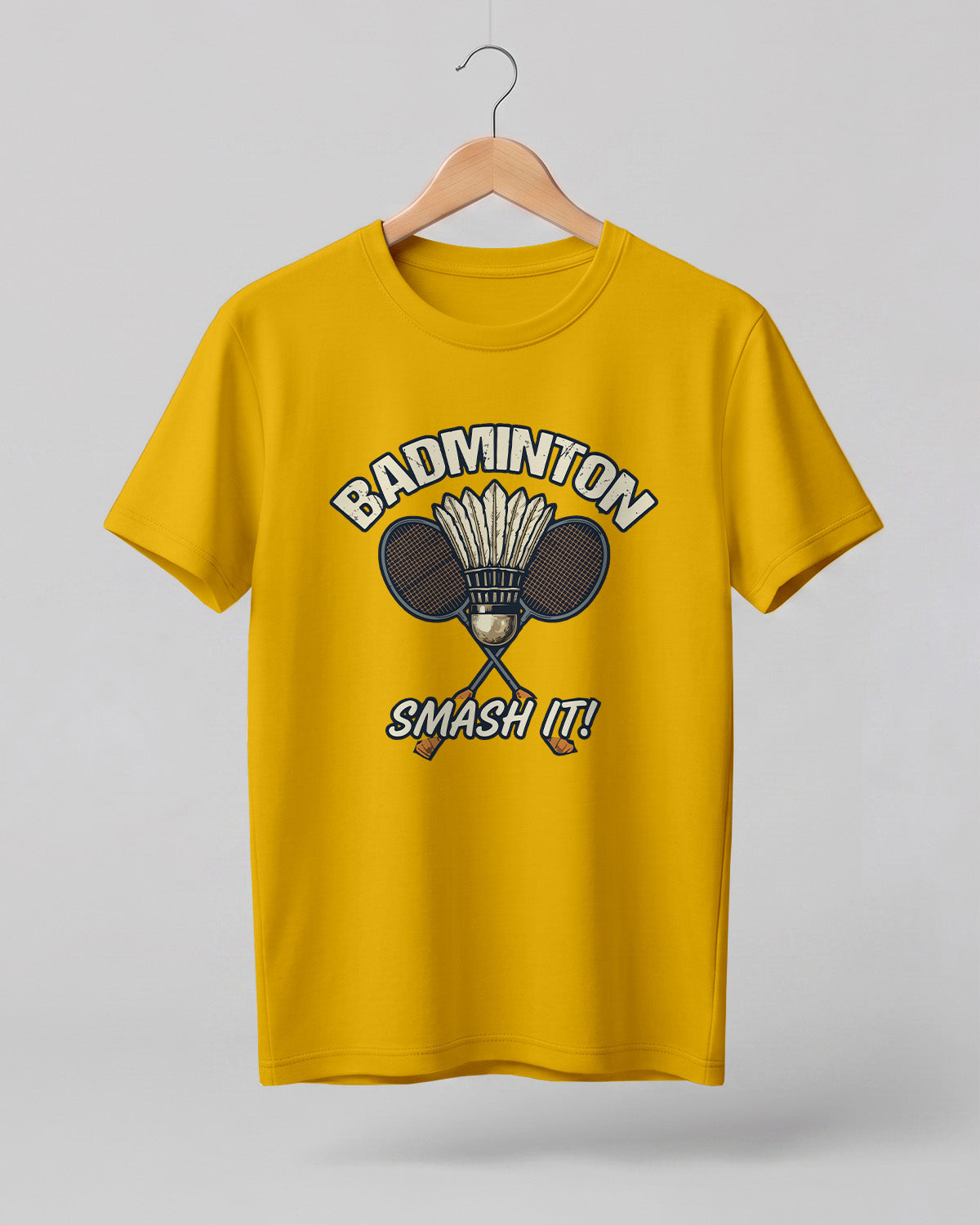Motivational sports graphic half sleeve t-shirt featuring “Badminton Smash It!” typography with crossed racket and shuttlecock design printed on premium cotton fabric.