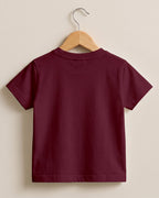 Maroon plain kids half sleeve round neck t-shirt made from premium cotton, 180 GSM yarn, biowashed for softness and durability.