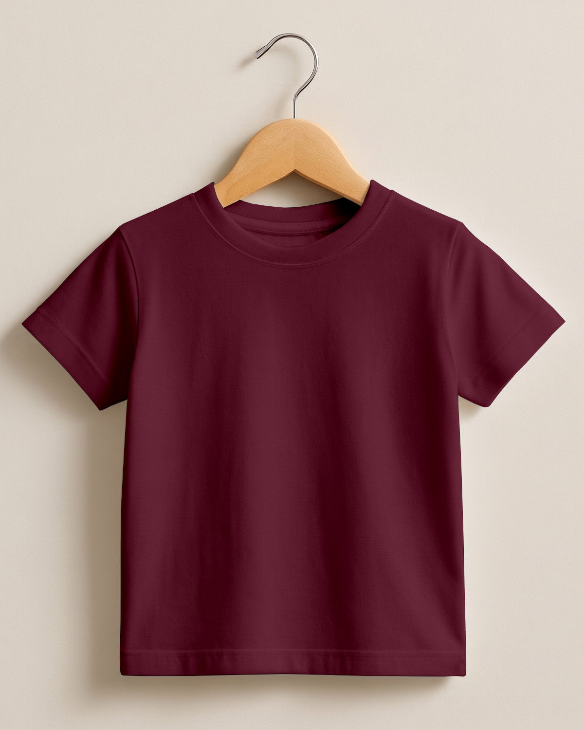 Maroon plain kids half sleeve round neck t-shirt made from premium cotton, 180 GSM yarn, biowashed for softness and durability.
